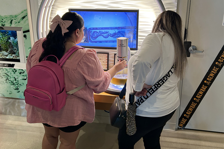 Guests viewing a specimen at the Micro Eye